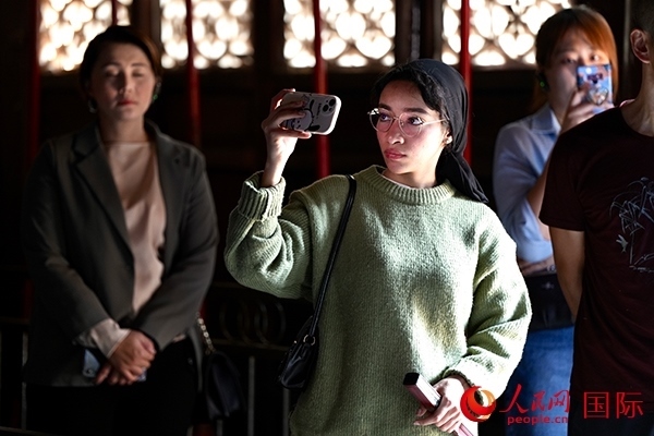 選手顏青（蘇丹）用手機(jī)記錄所見所感。人民網(wǎng) 盧鵬宇攝