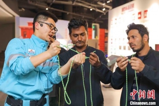 5月9日，工作人員指導留學生學習打繩結。張鷹 攝