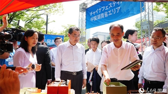 湖南展位工作人員向中國駐日本大使吳江浩介紹特色文創(chuàng)產(chǎn)品。人民網(wǎng) 蔣曉辰攝