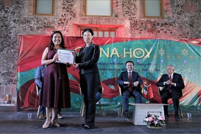 李雅芳向加比拉爾·塞迪略授予“拉美分社榮譽(yù)員工”稱號。主辦方供圖