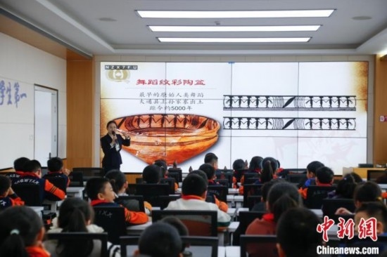 圖為學生在“國寶音樂會”社教課中了解舞蹈紋彩陶盆。中新社記者 馬銘言 攝